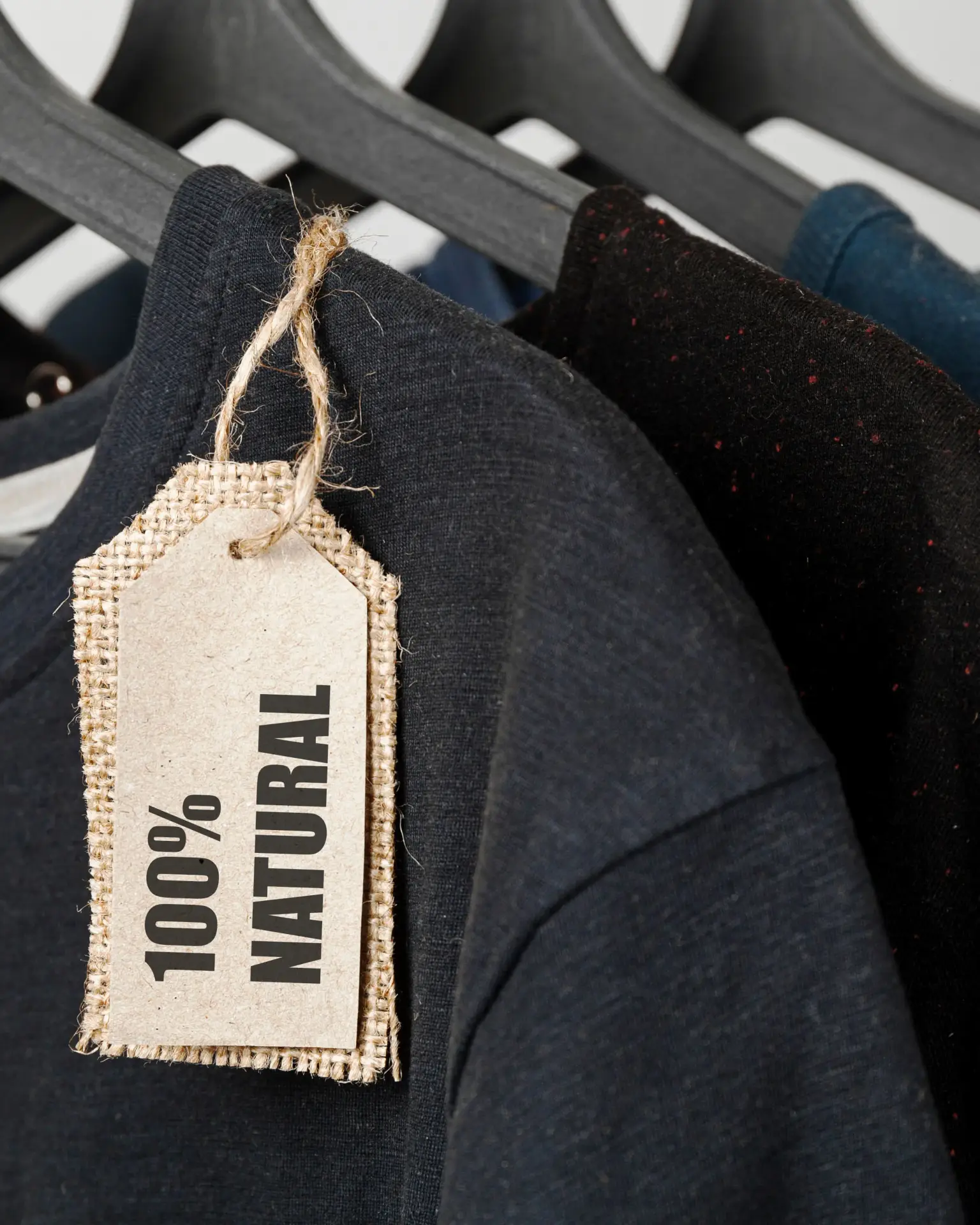 Sustainable T-shirts made from organic cotton – 100% natural Clothing made from 100% natural materials – bio T-shirts on hangers with sustainability tags