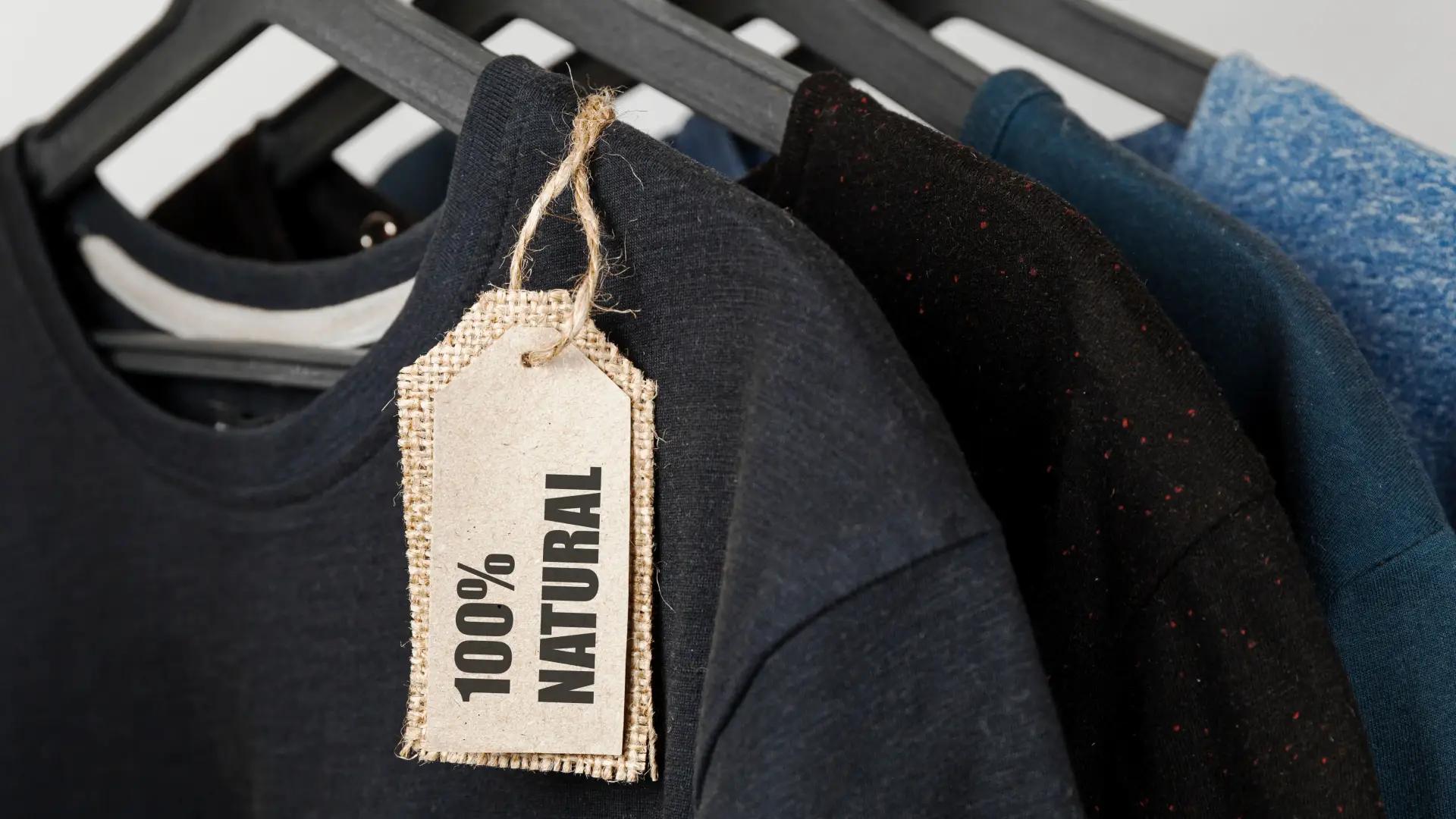Sustainable T-shirts made from organic cotton – 100% natural Clothing made from 100% natural materials – bio T-shirts on hangers with sustainability tags