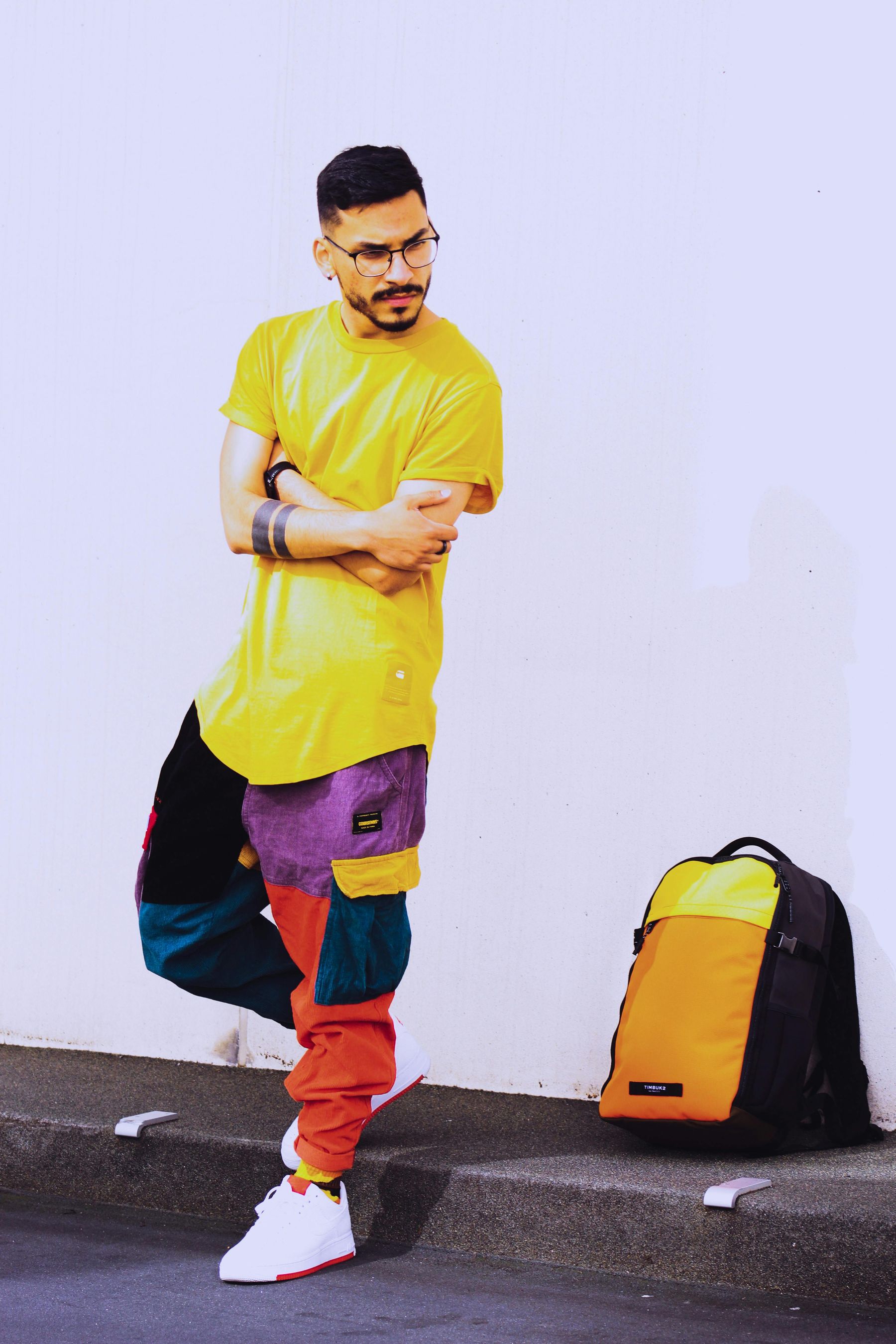 Young man with yellow T-shirt and colorful pants